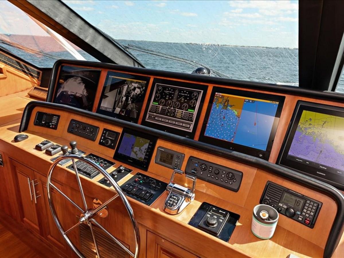 a desk with a laptop and a camera on it aboard EVA VII Yacht for Sale