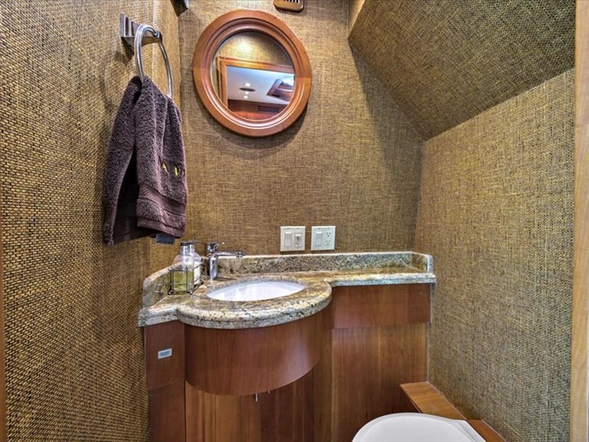 a bathroom with a round mirror aboard EVA VII Yacht for Sale