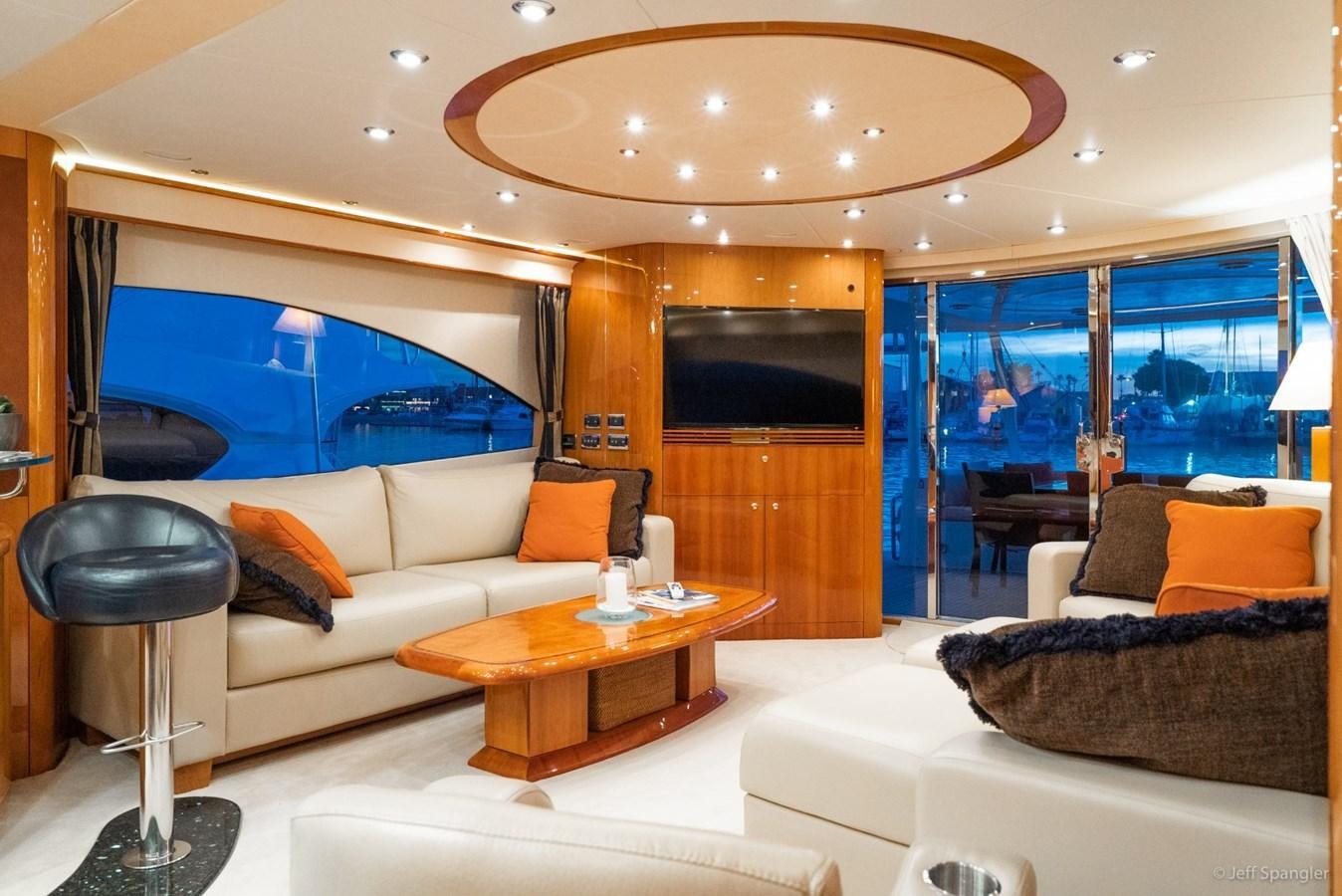 a room with a couch and a table and a tv aboard NAKOA Yacht for Sale