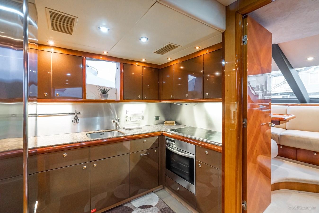 a kitchen with wooden cabinets aboard NAKOA Yacht for Sale