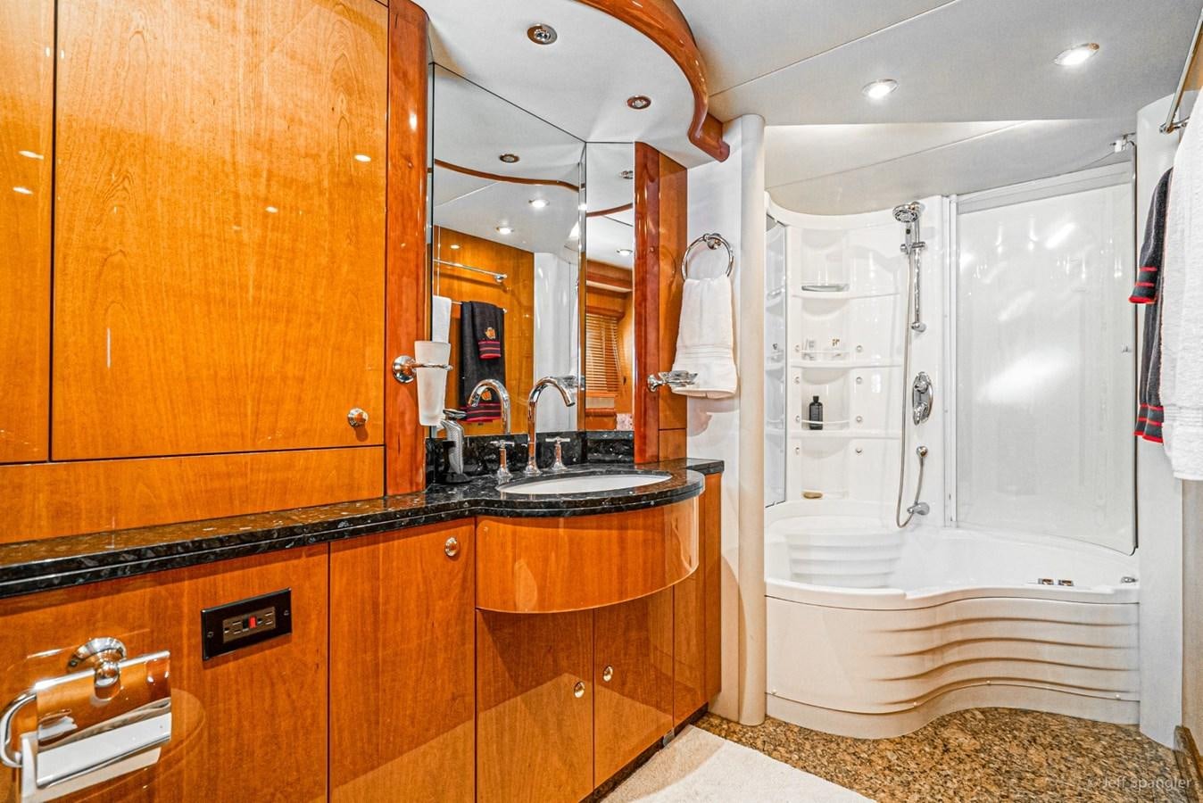 a bathroom with a bathtub and sink aboard NAKOA Yacht for Sale