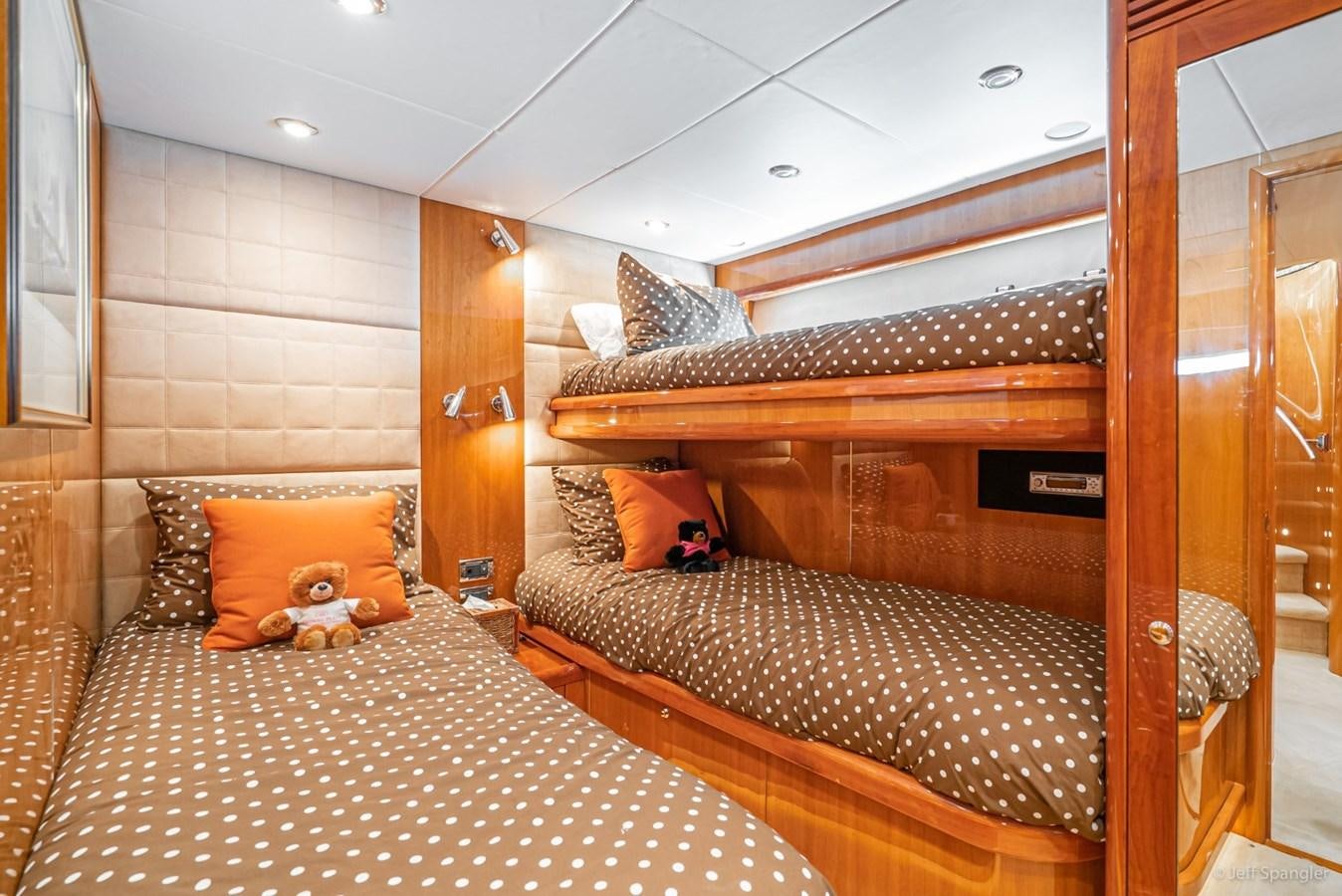 a small bedroom with a bed aboard NAKOA Yacht for Sale