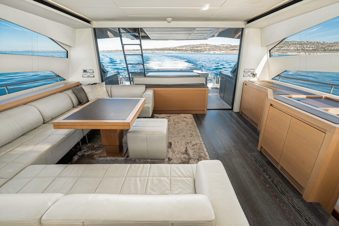 a room with a table and chairs aboard MO T0WN Yacht for Sale