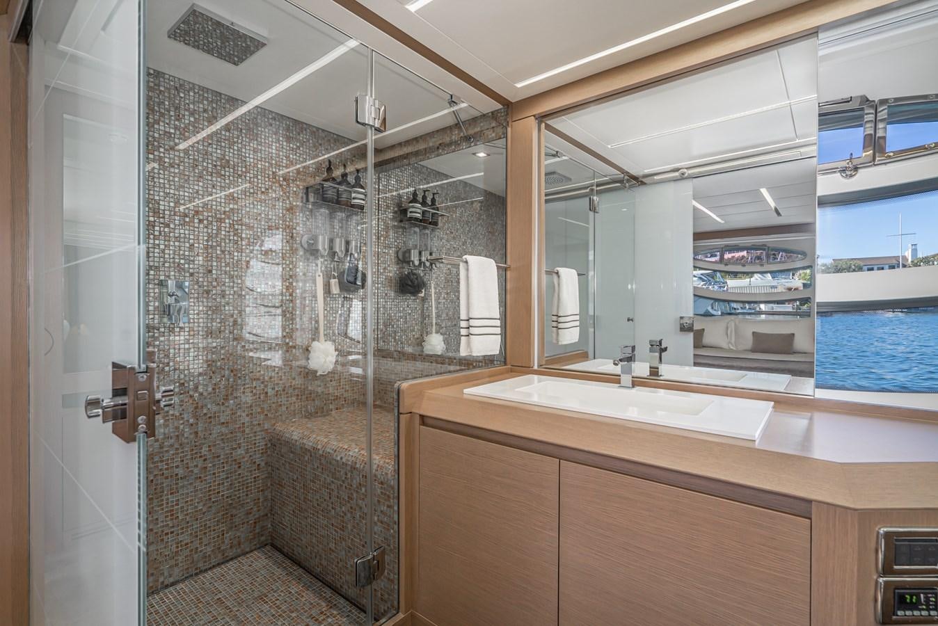 a bathroom with a glass shower aboard MO T0WN Yacht for Sale