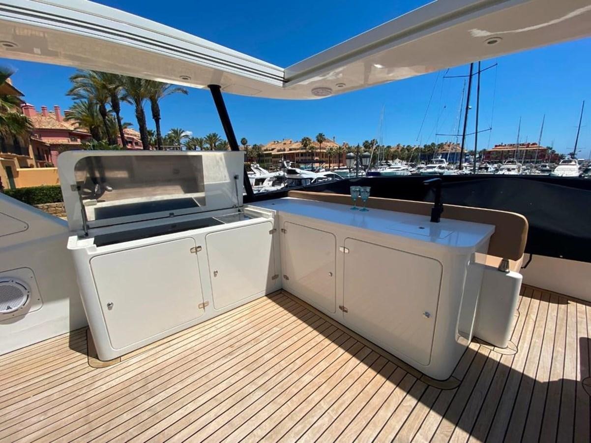 a deck with a deck and a view of the water aboard YAIZA T Yacht for Sale