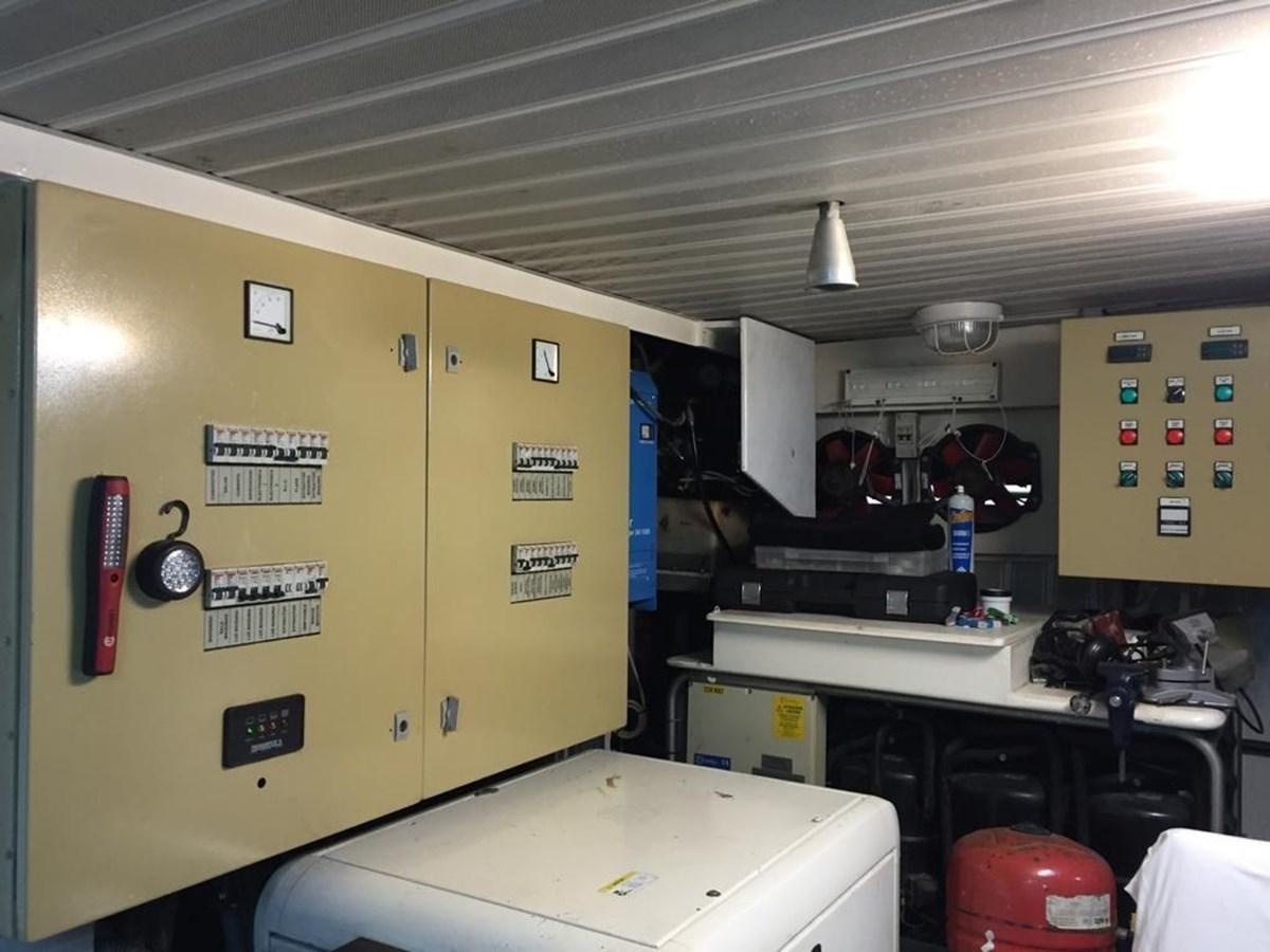 a room with yellow walls and a white table with a white table and red chairs aboard YAIZA T Yacht for Sale