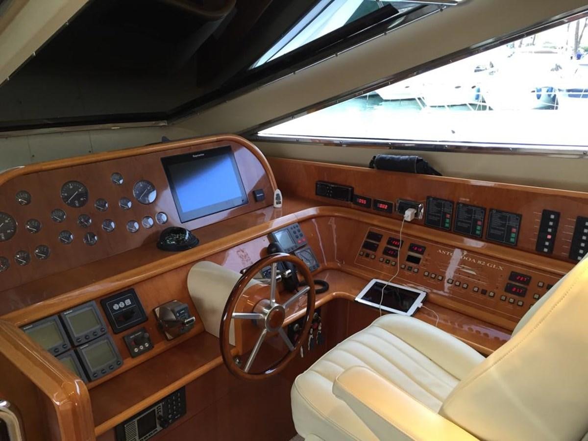 a wooden desk with a computer and other electronics on it aboard YAIZA T Yacht for Sale