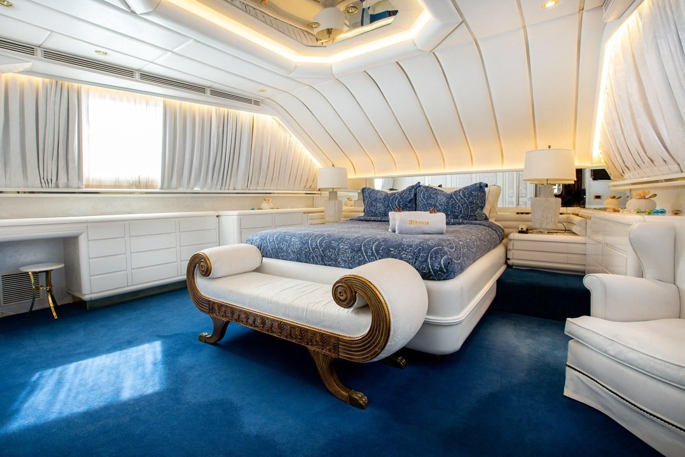 a large bedroom with a blue rug aboard ALDONZA Yacht for Sale
