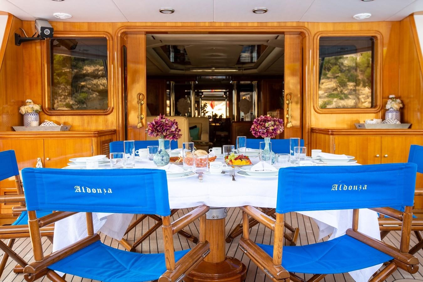 a dining room with blue tables and chairs aboard ALDONZA Yacht for Sale