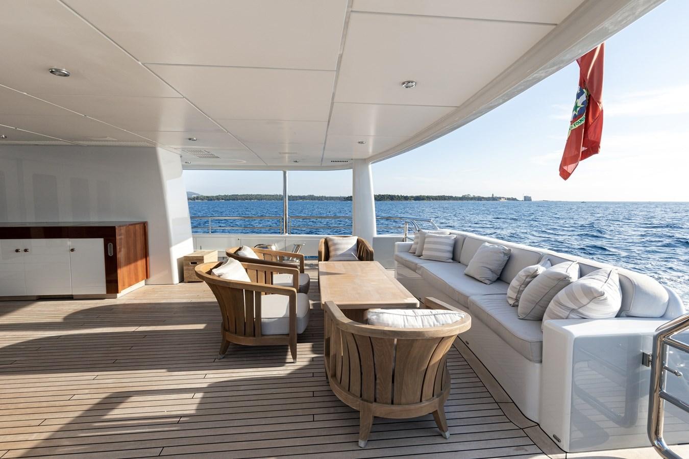 a room with a bed and a table and chairs aboard WERE DREAMS Yacht for Sale