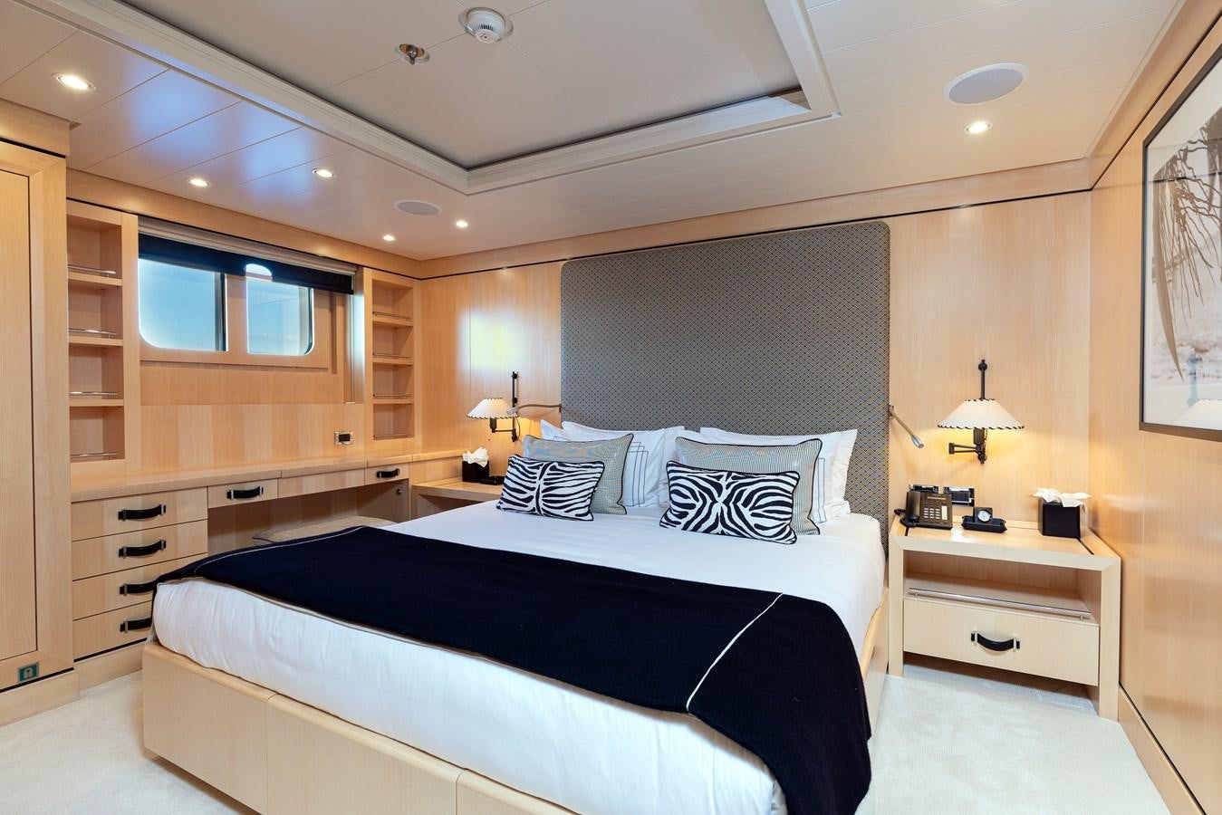 a bedroom with a bed and a desk aboard WERE DREAMS Yacht for Sale