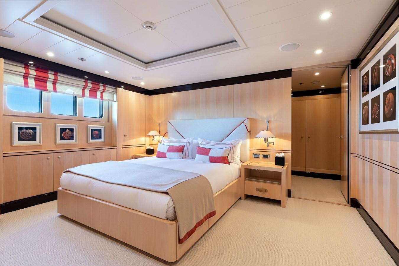 a bedroom with a bed and a desk aboard WERE DREAMS Yacht for Sale