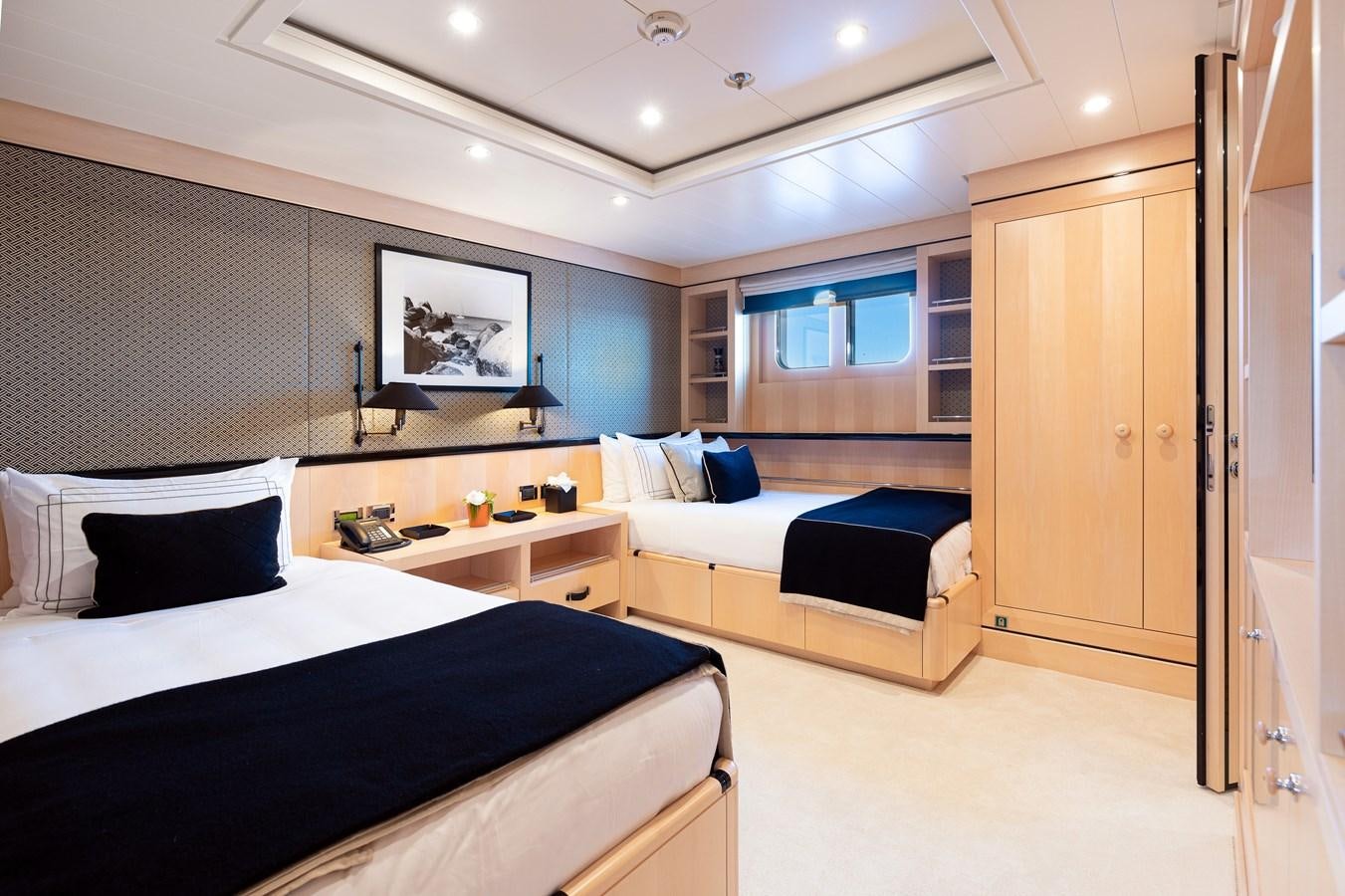 a room with a couple beds aboard WERE DREAMS Yacht for Sale