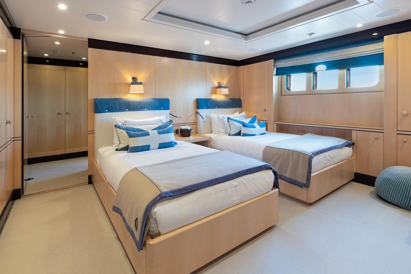 a room with beds and a lamp aboard WERE DREAMS Yacht for Sale