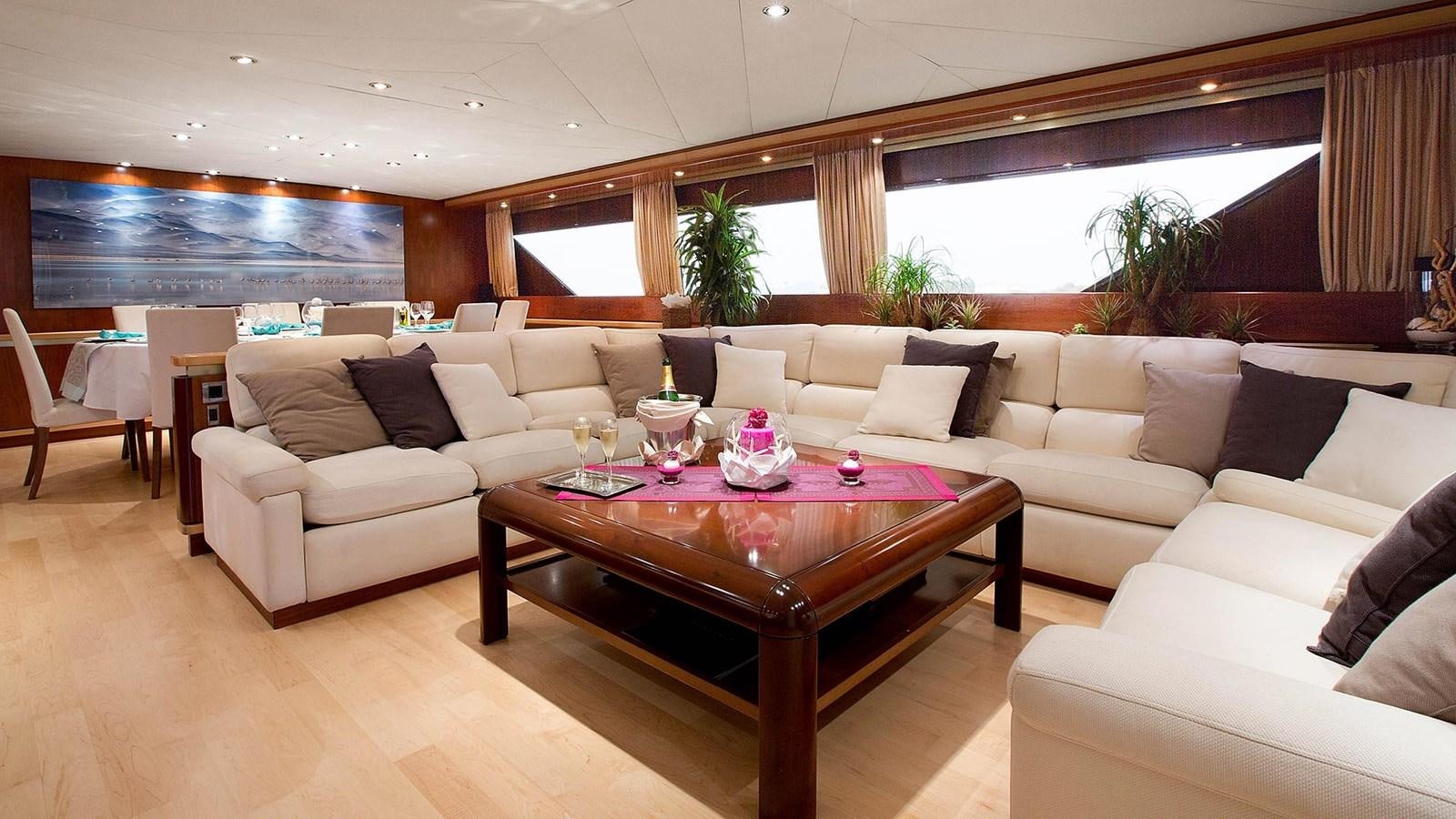 a living room with a table and couches aboard SUNLINER X Yacht for Sale