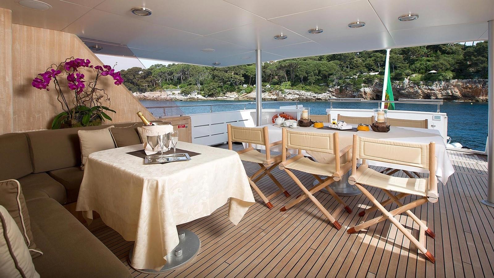 a table and chairs on a deck aboard SUNLINER X Yacht for Sale