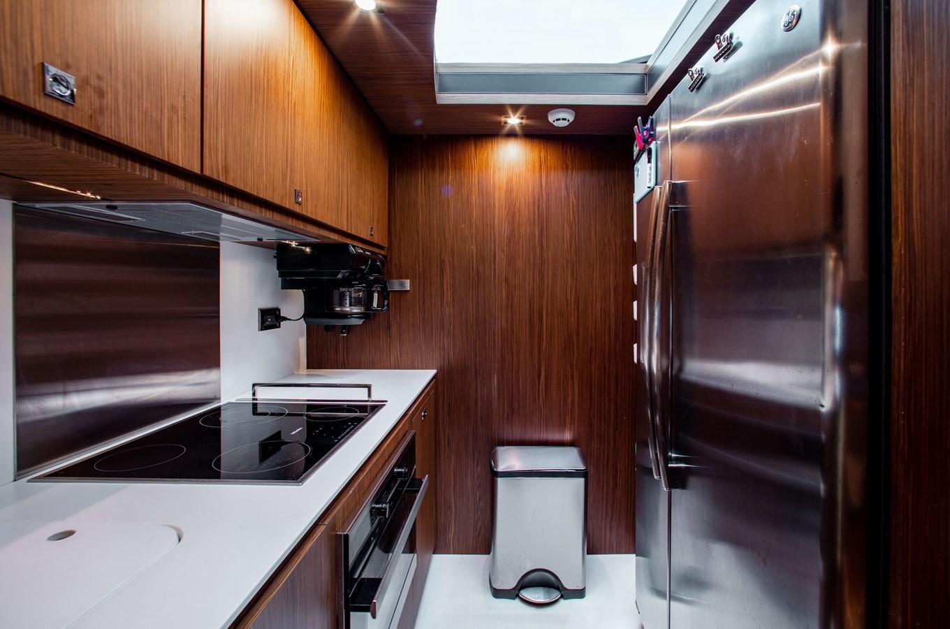 a kitchen with wooden cabinets aboard MOVIN DAY Yacht for Sale