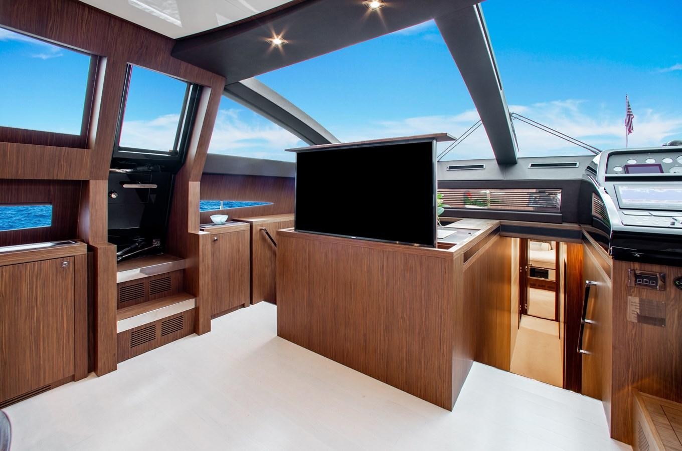 a room with a tv and a wood cabinet aboard MOVIN DAY Yacht for Sale