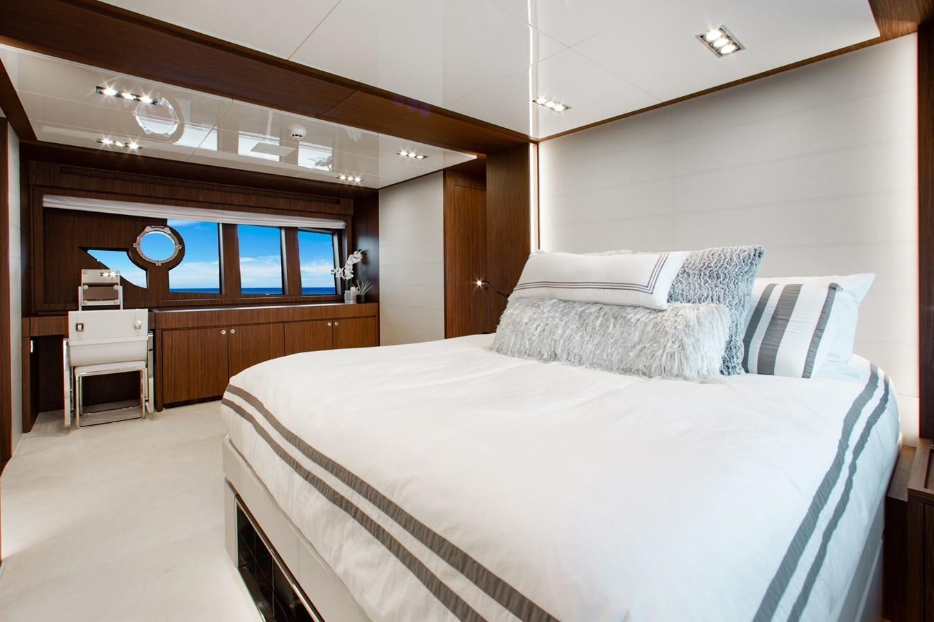 a bedroom with a bed and a desk aboard MOVIN DAY Yacht for Sale