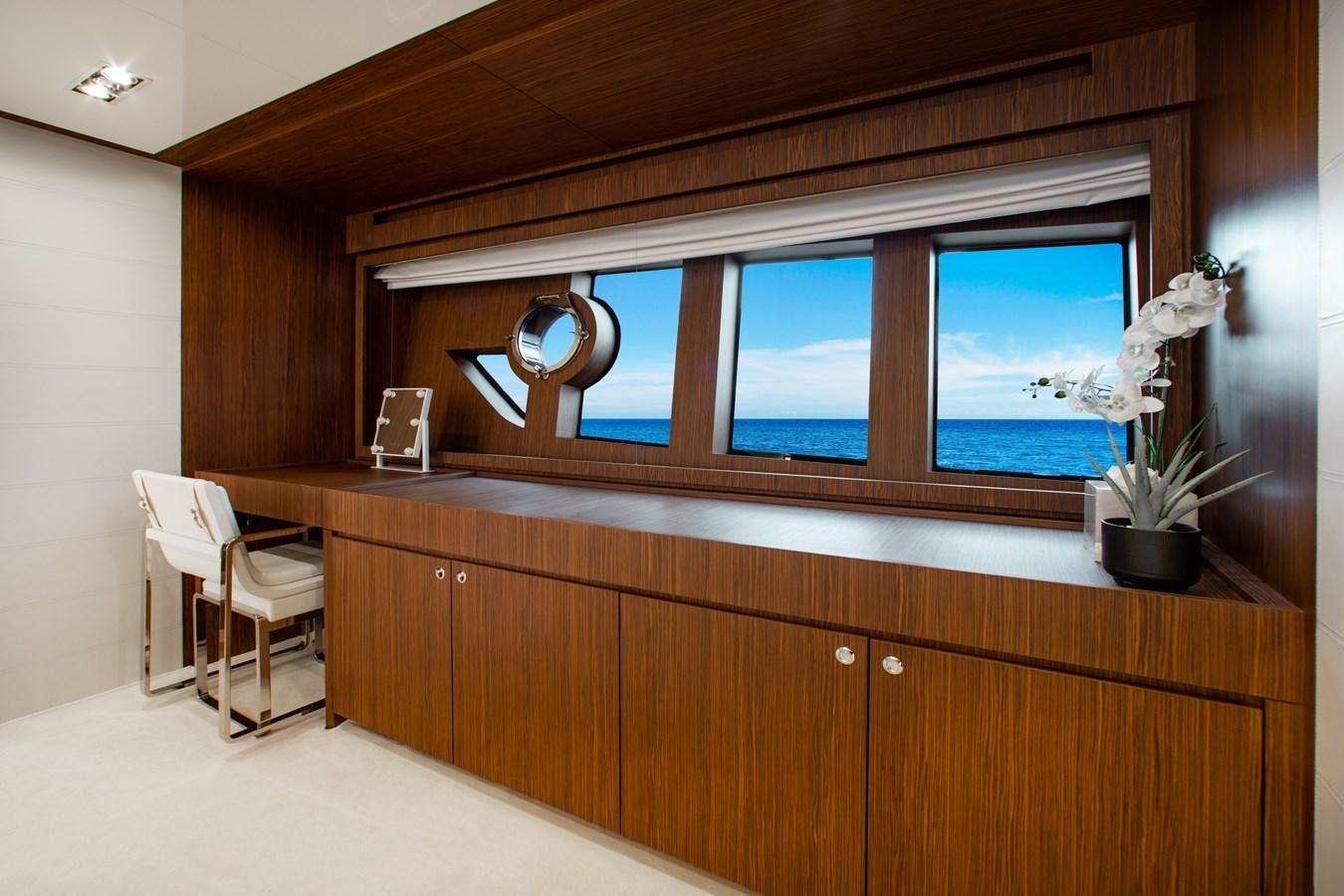 a room with a large window and wood cabinets aboard MOVIN DAY Yacht for Sale