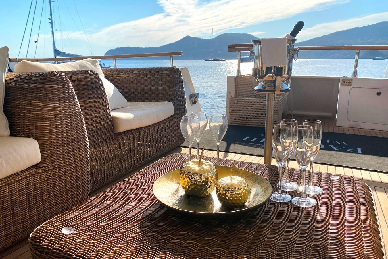 a table with wine glasses and food on it aboard PAULA III Yacht for Sale