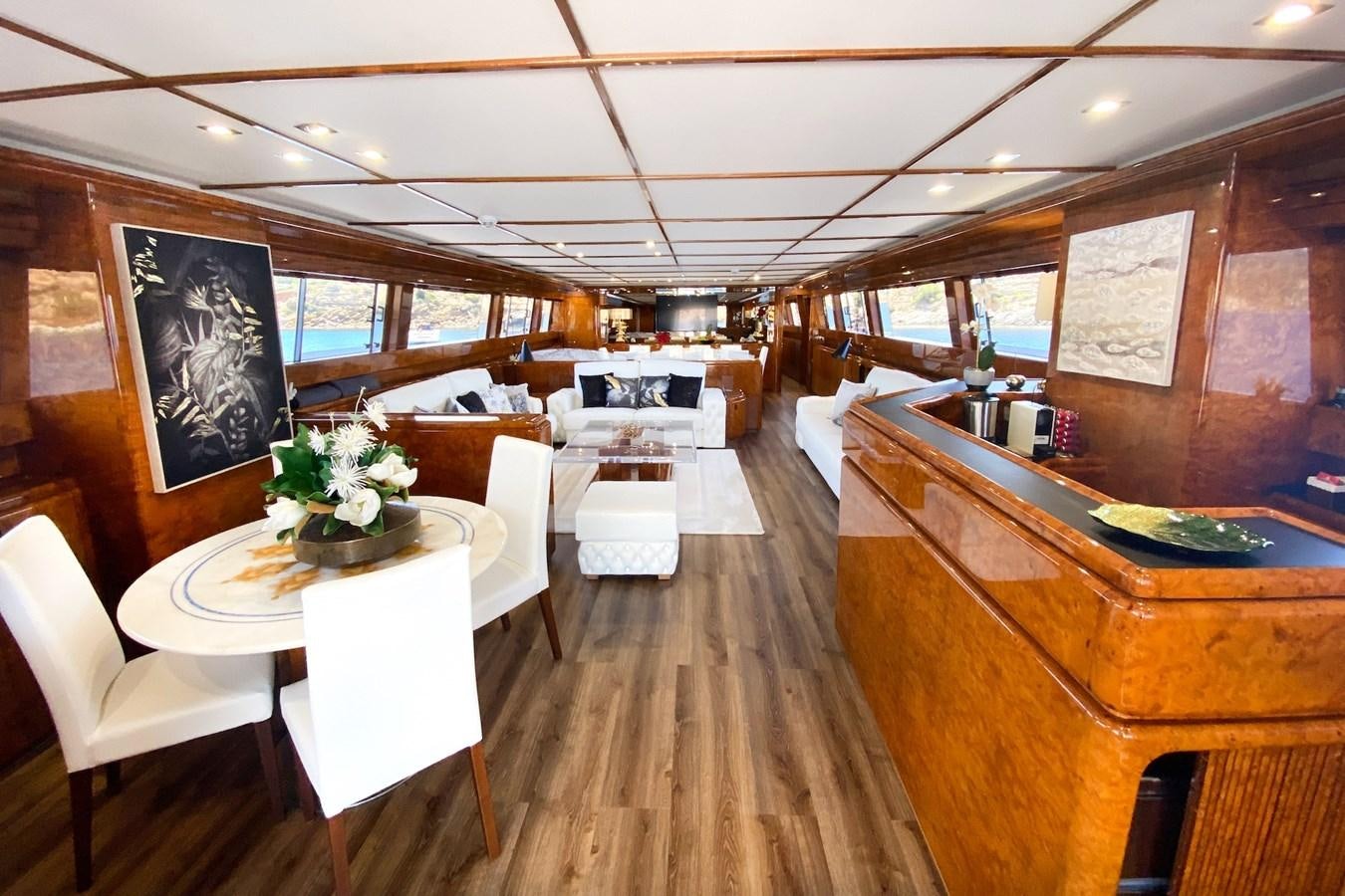 a room with tables and chairs aboard PAULA III Yacht for Sale