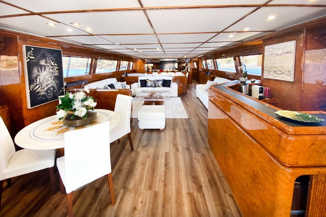 a room with tables and chairs aboard PAULA III Yacht for Sale