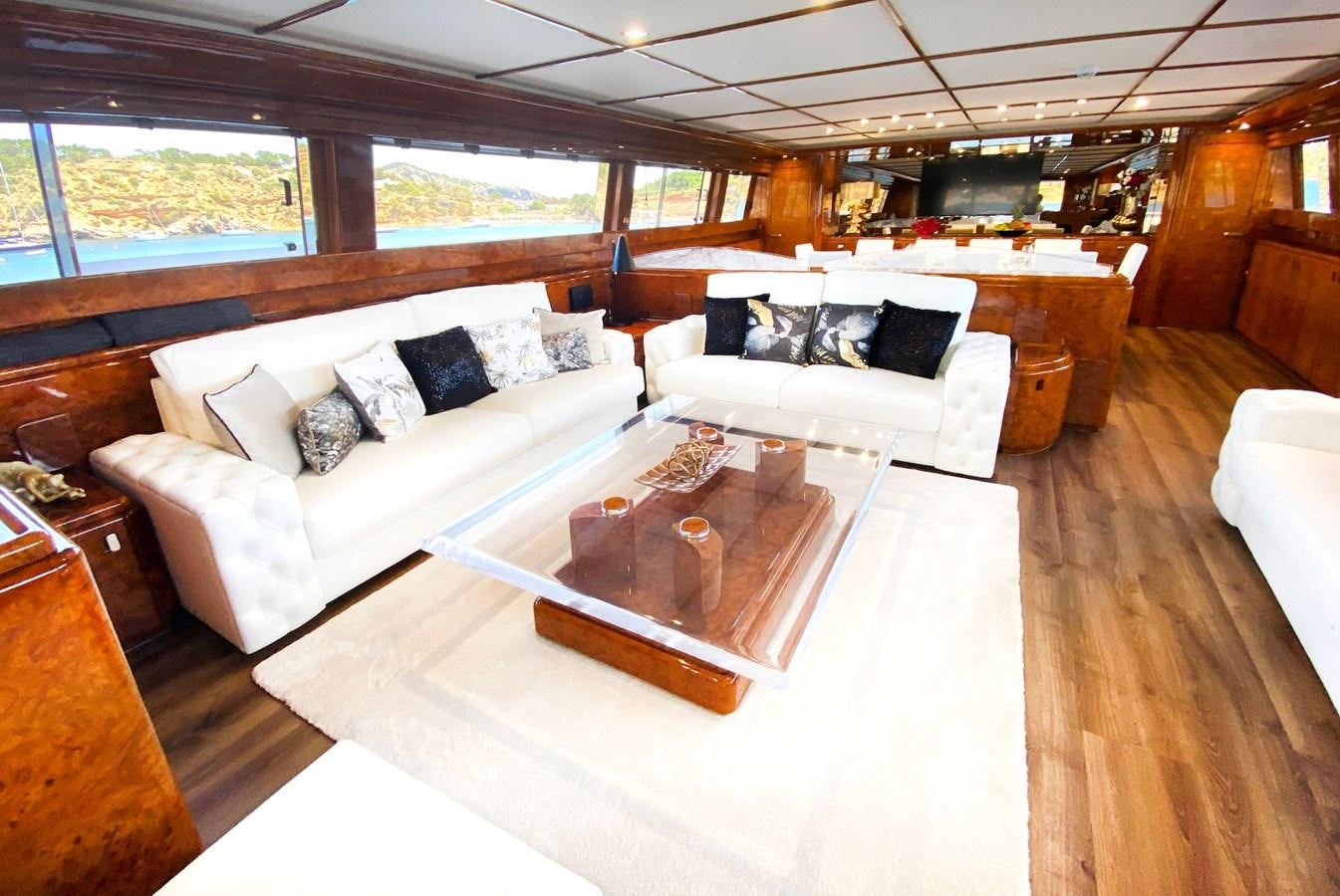 a living room with a couch and a coffee table aboard PAULA III Yacht for Sale
