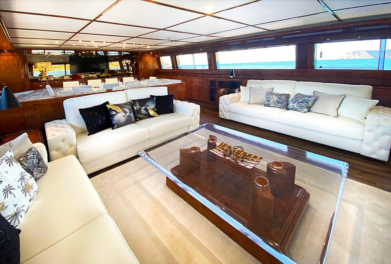 a living room with a couch and a coffee table aboard PAULA III Yacht for Sale