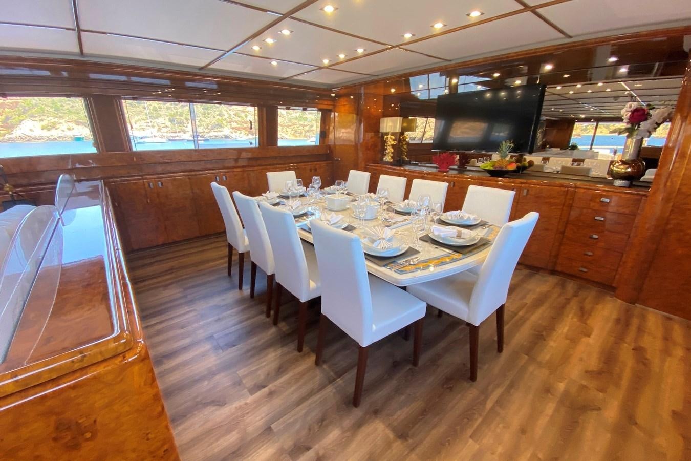 a dining room with a table and chairs aboard PAULA III Yacht for Sale