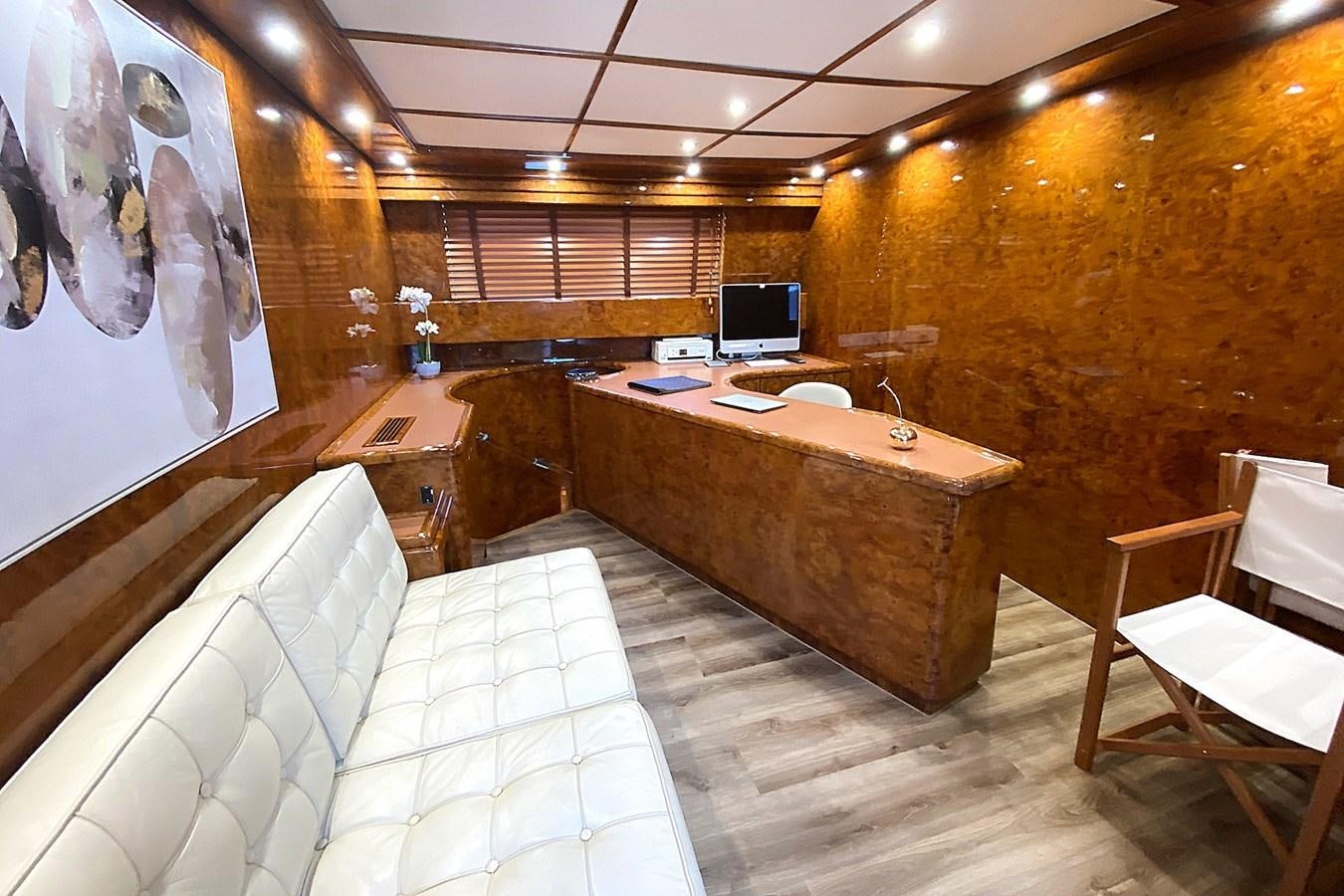 a room with a bed and a desk aboard PAULA III Yacht for Sale