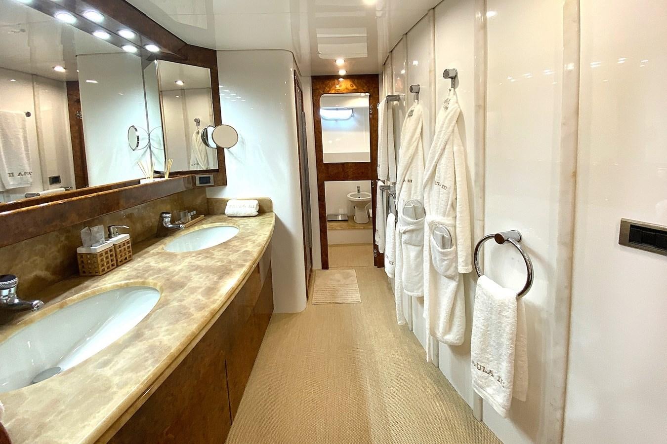a bathroom with a countertop sink and a mirror aboard PAULA III Yacht for Sale