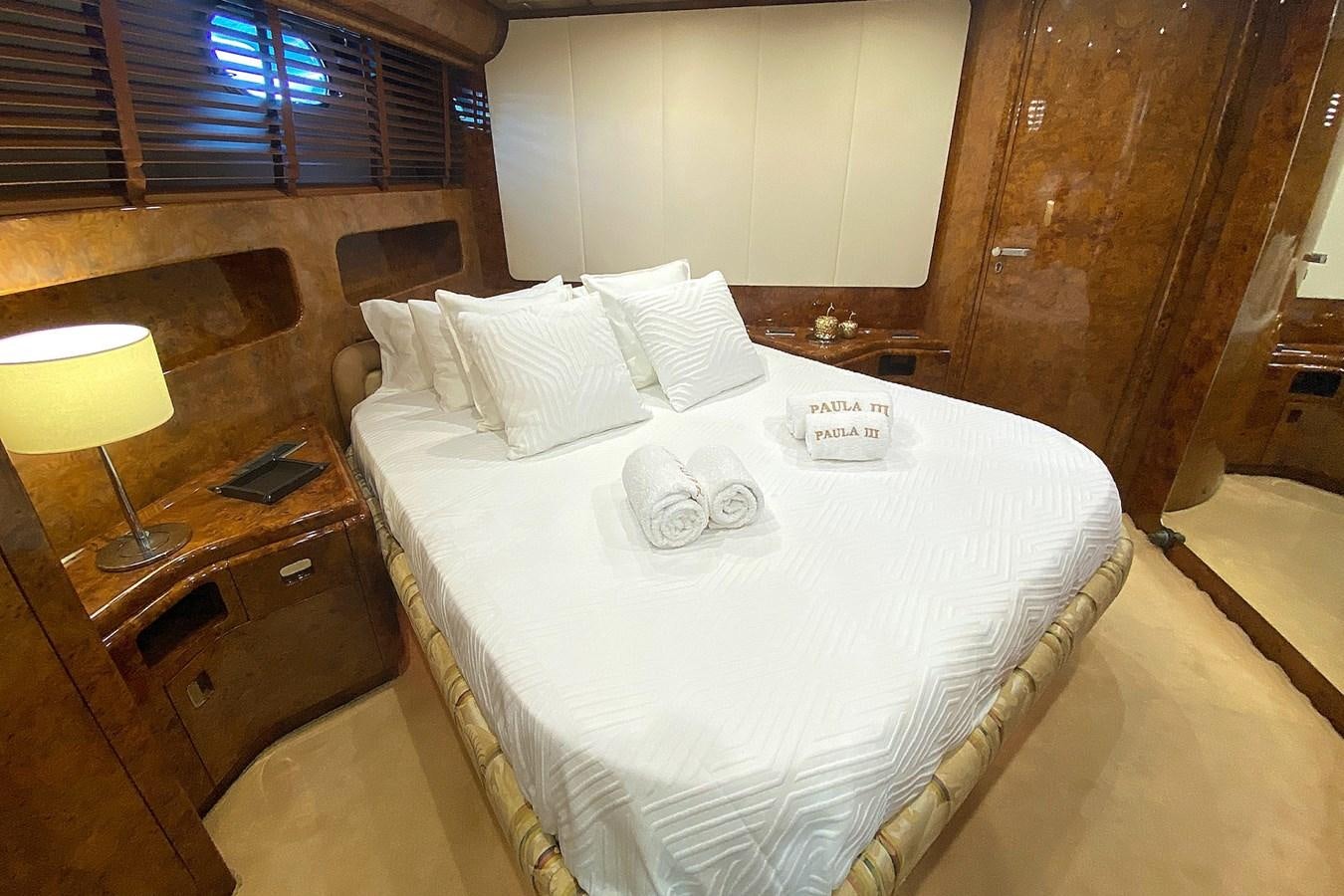 a bed with white sheets aboard PAULA III Yacht for Sale
