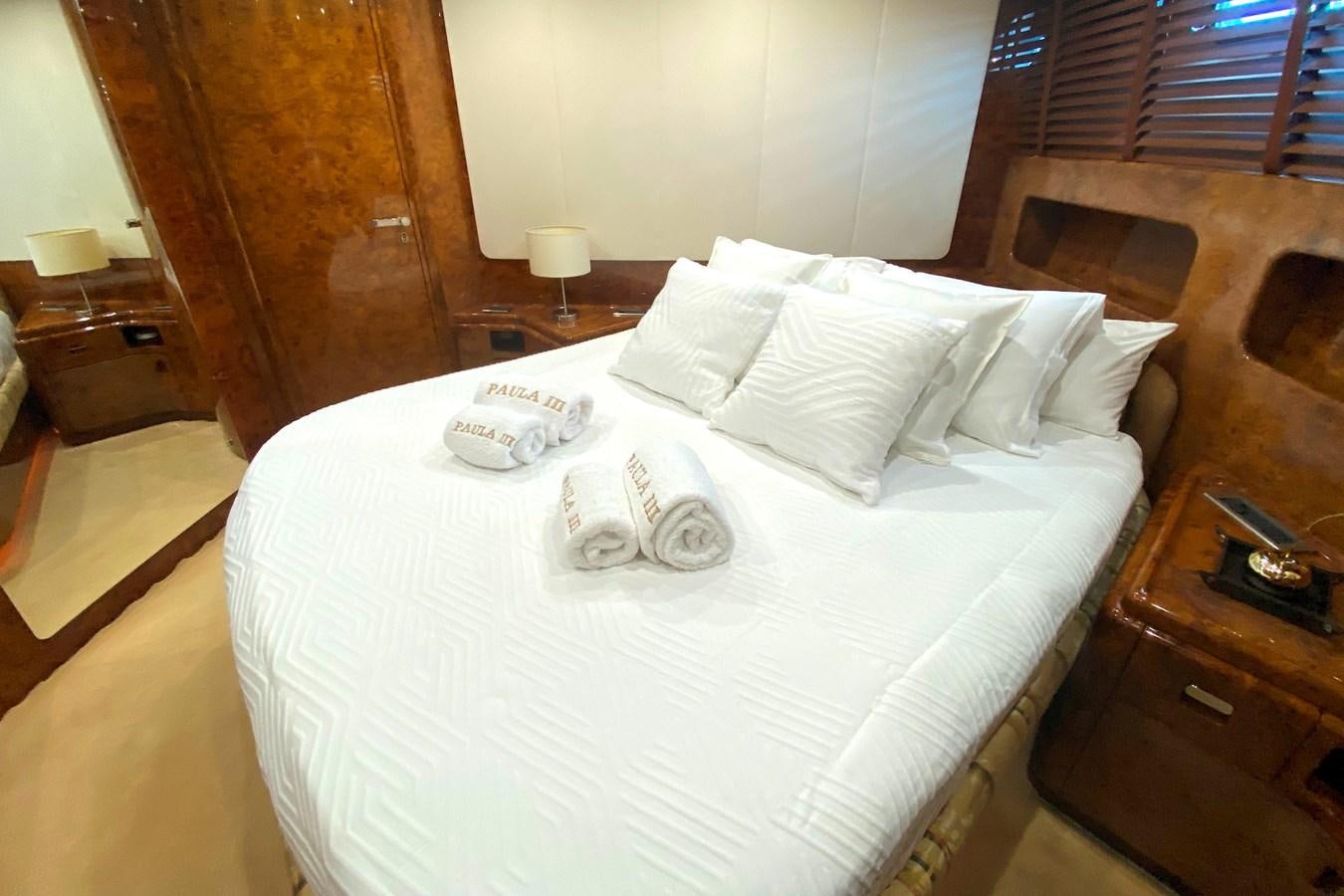 a bed with white sheets aboard PAULA III Yacht for Sale