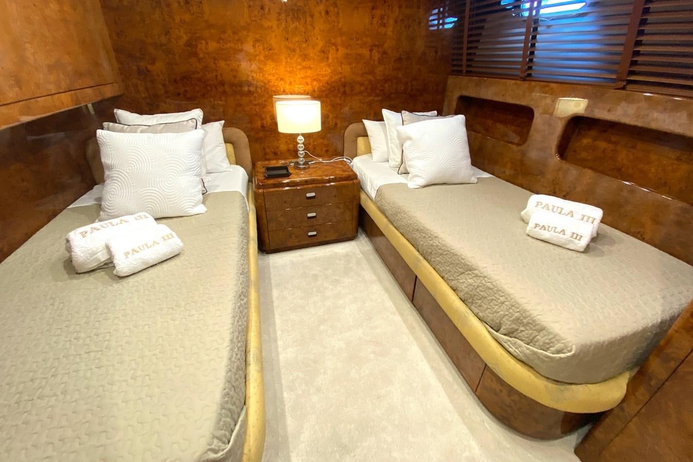 a room with beds and a table aboard PAULA III Yacht for Sale