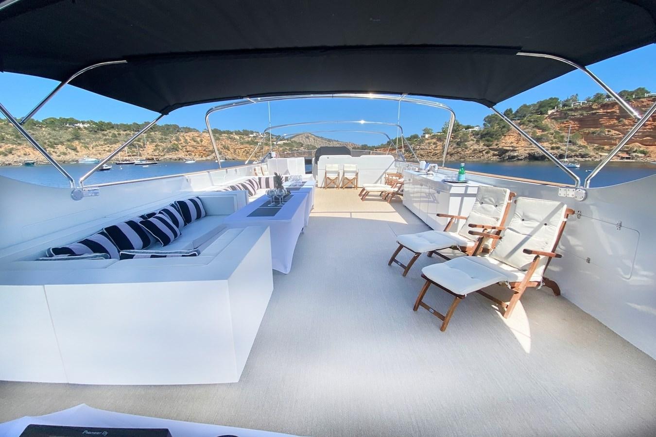 a room with a bed and chairs aboard PAULA III Yacht for Sale