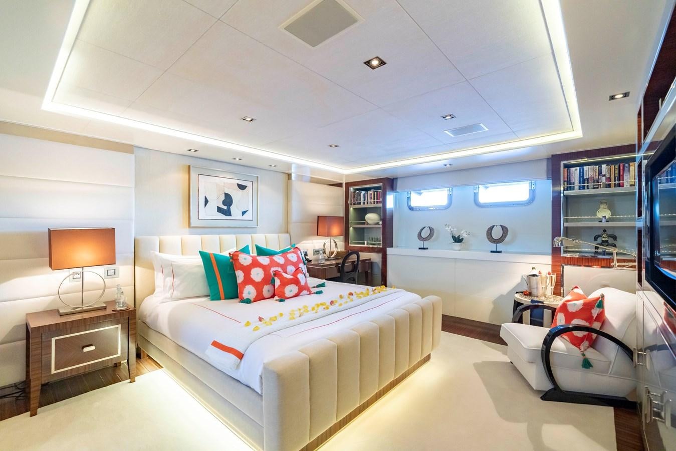 a bedroom with a bed and a chair aboard TIMBUKTU Yacht for Charter