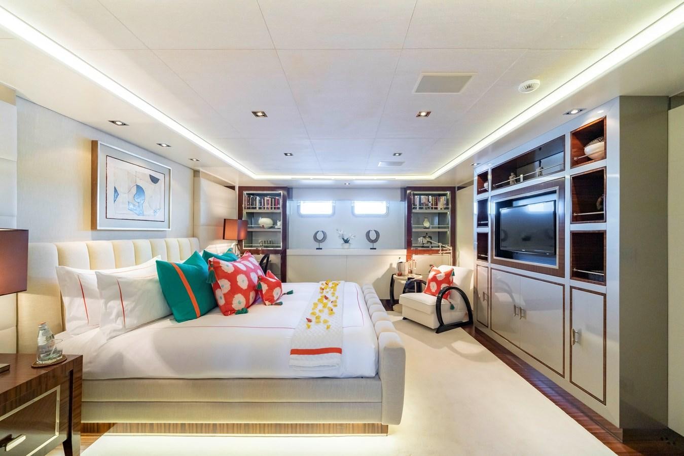 a bedroom with a bed and a tv aboard TIMBUKTU Yacht for Charter