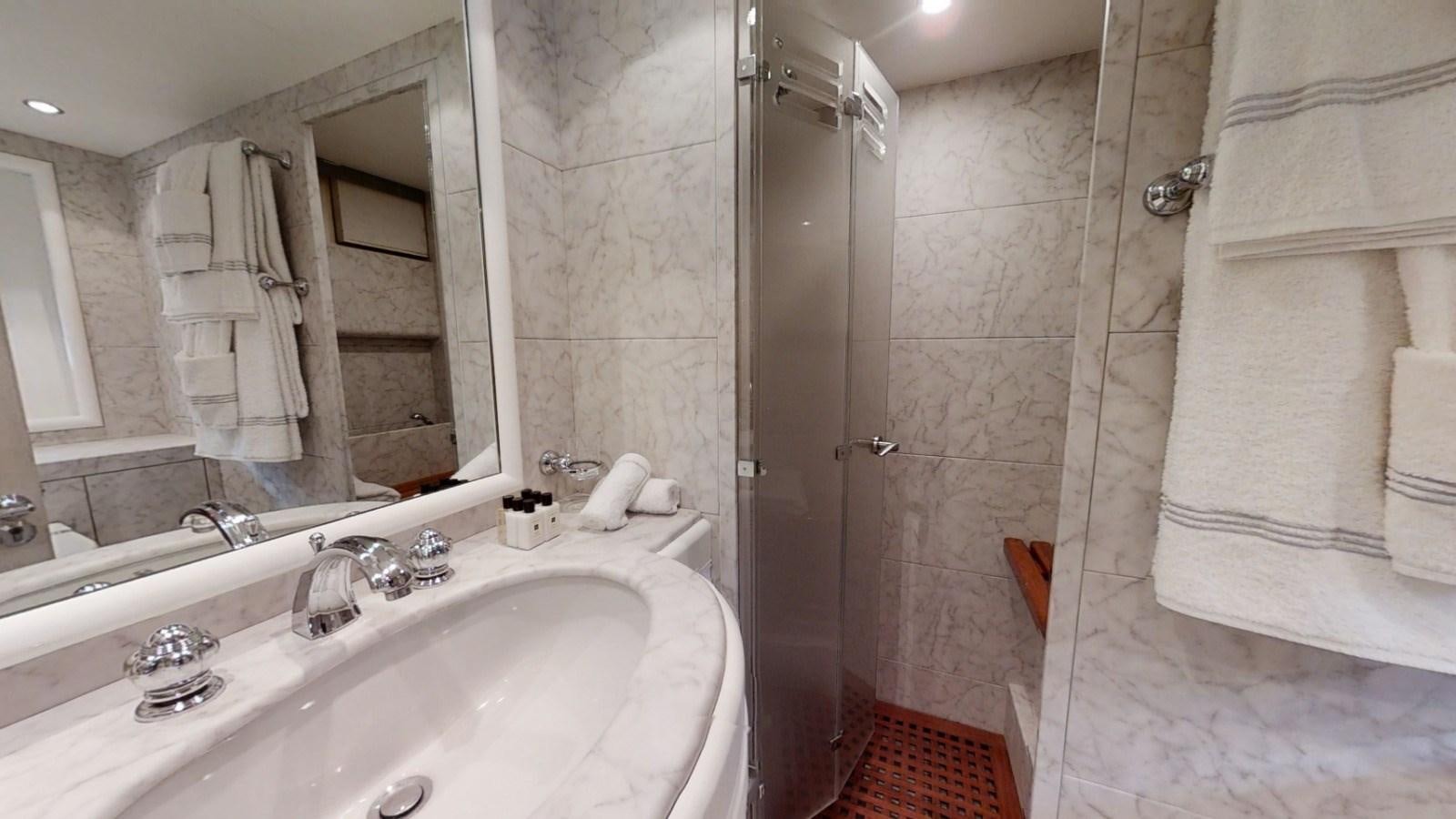a bathroom with a large mirror aboard LAUREN V Yacht for Sale