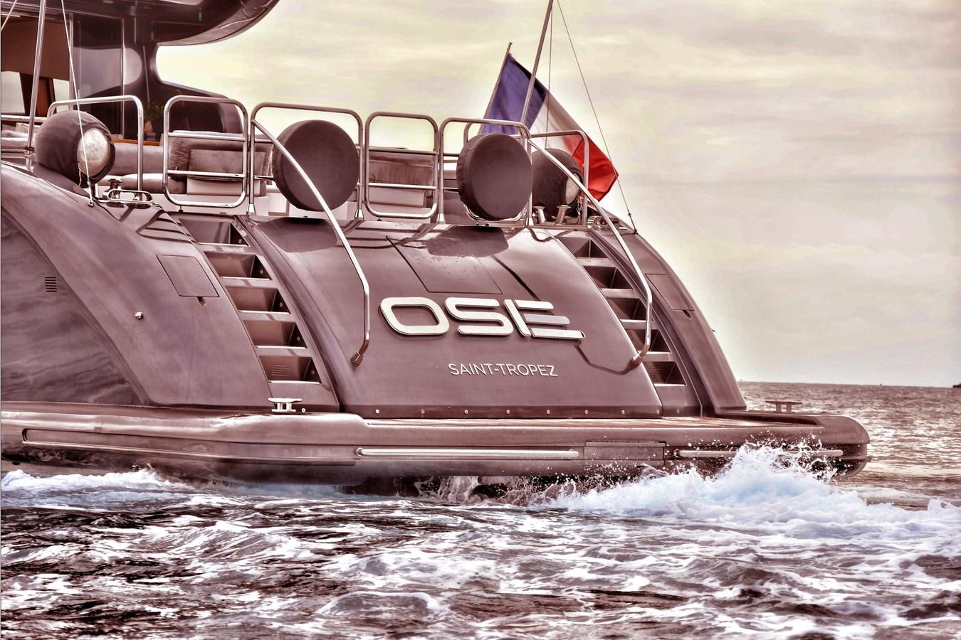 a boat with flags on it aboard OSE Yacht for Sale