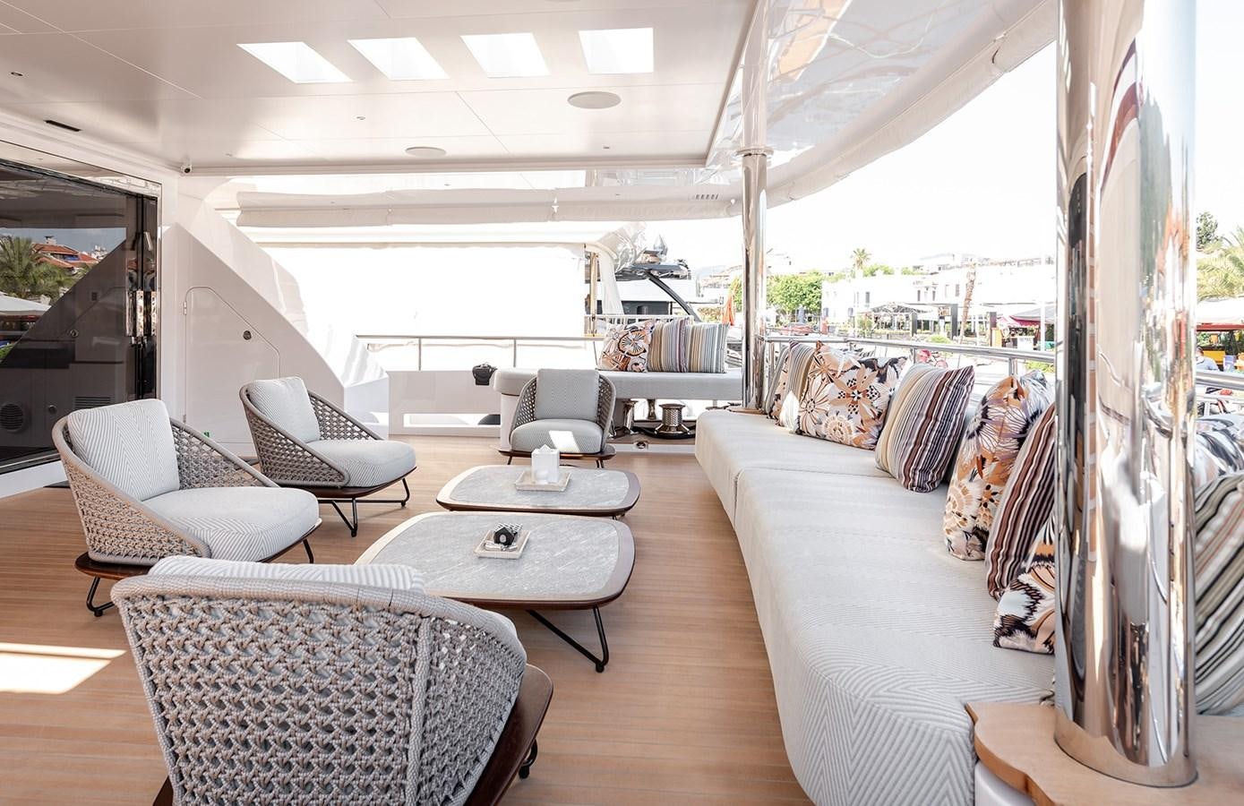 a room with a table chairs and a couch aboard M55 Yacht for Sale