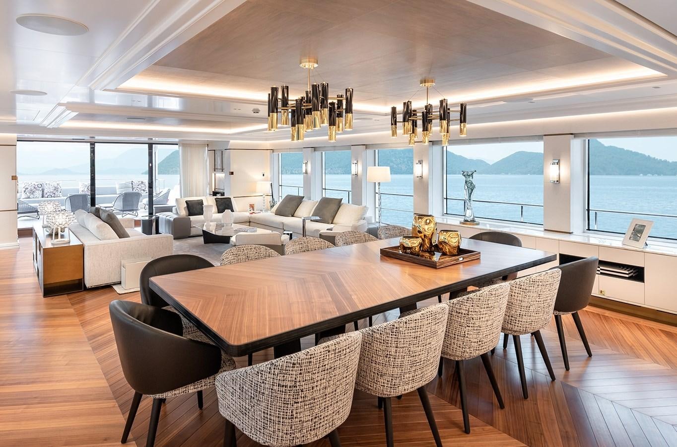 a large living room with a large dining table aboard M55 Yacht for Sale