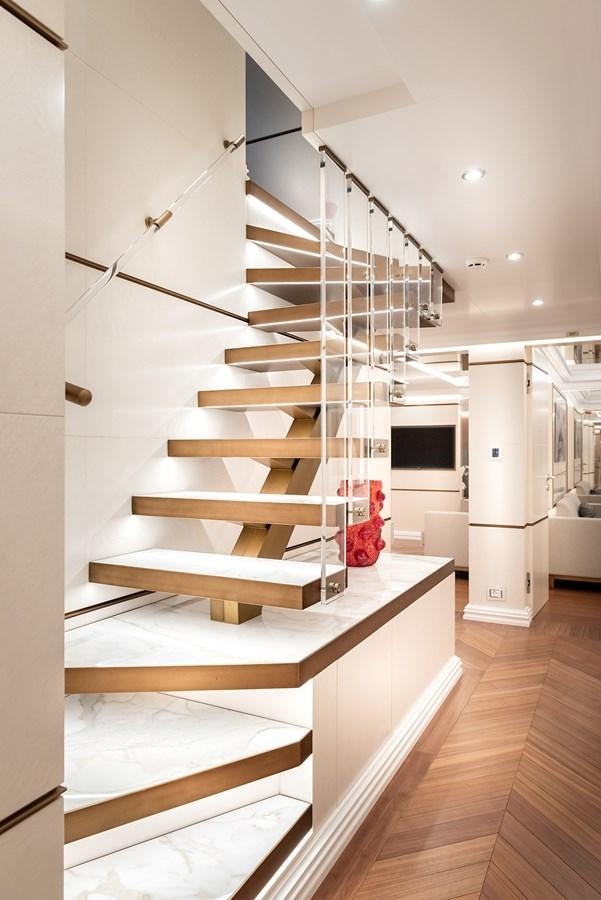 a white staircase with white walls aboard M55 Yacht for Sale