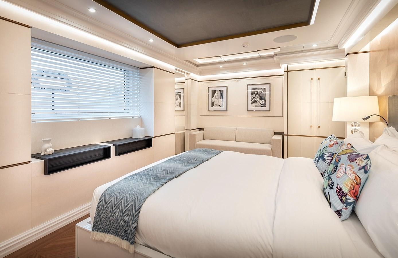 a bedroom with a bed and a television aboard M55 Yacht for Sale
