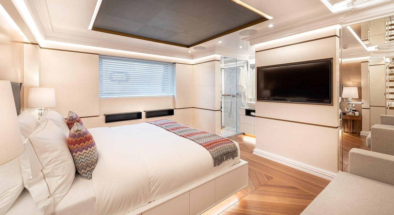 a bedroom with a bed and a tv aboard M55 Yacht for Sale