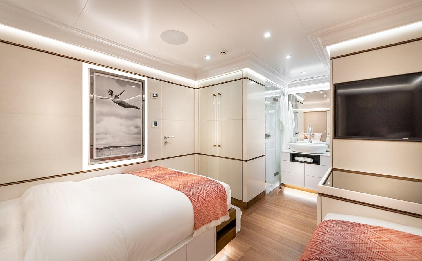 a bedroom with a bed and a tv aboard M55 Yacht for Sale