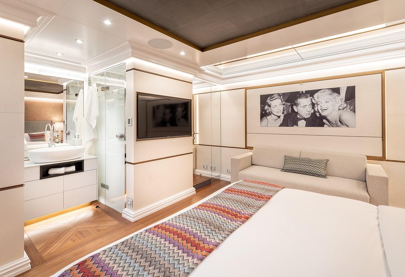 a bedroom with a bed and a television aboard M55 Yacht for Sale