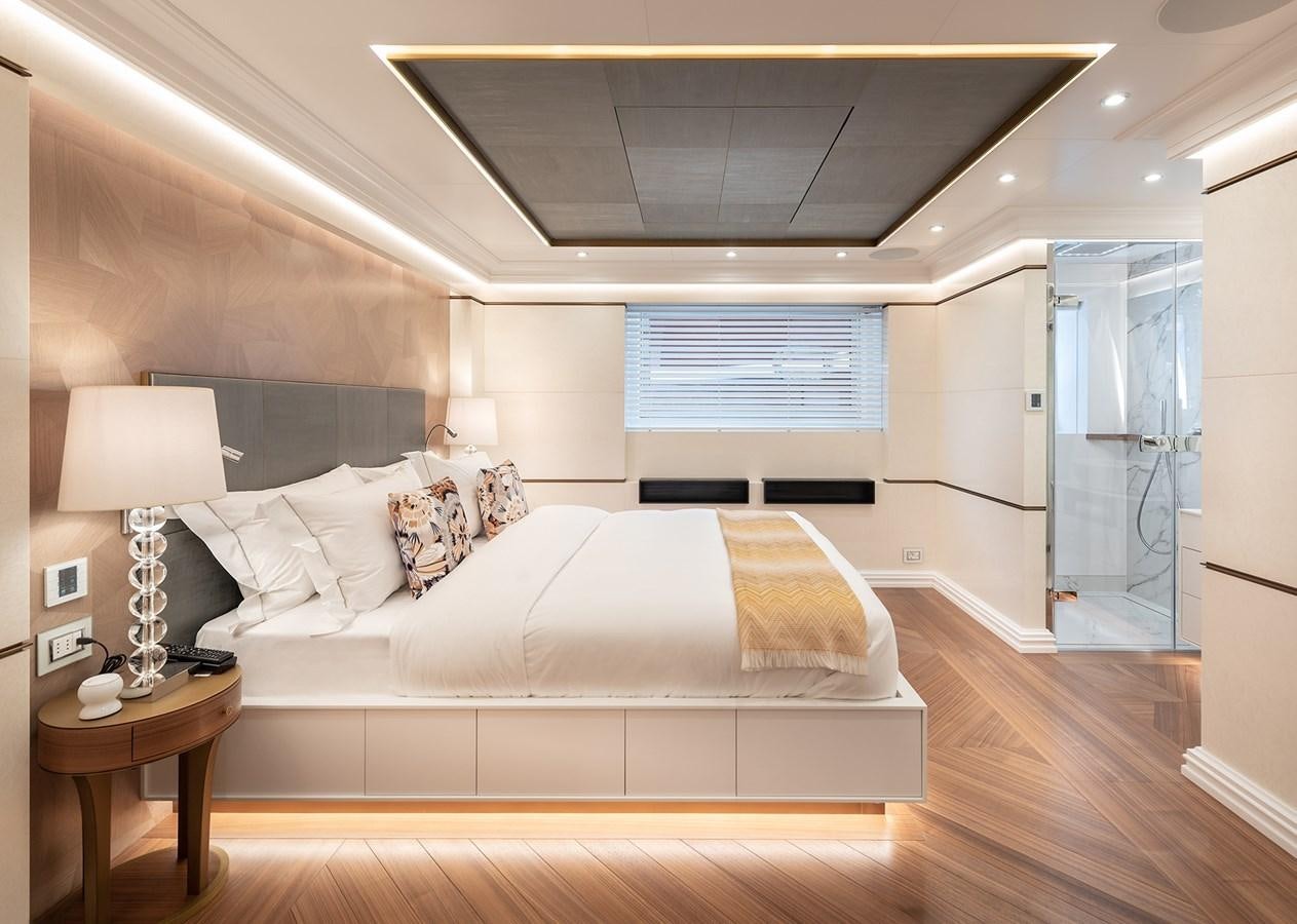 a large bedroom with a large bed aboard M55 Yacht for Sale
