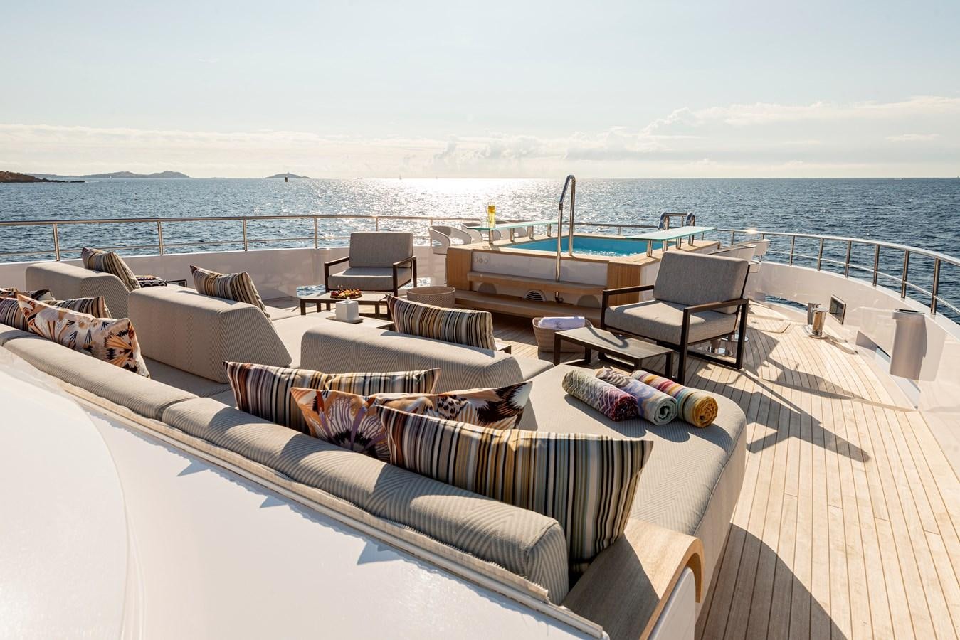 a deck with a large body of water and a large boat in the background aboard M55 Yacht for Sale