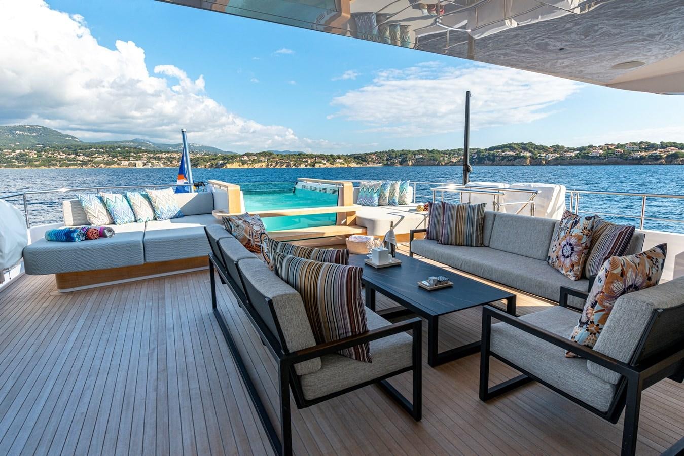 a patio with a table and chairs aboard M55 Yacht for Sale